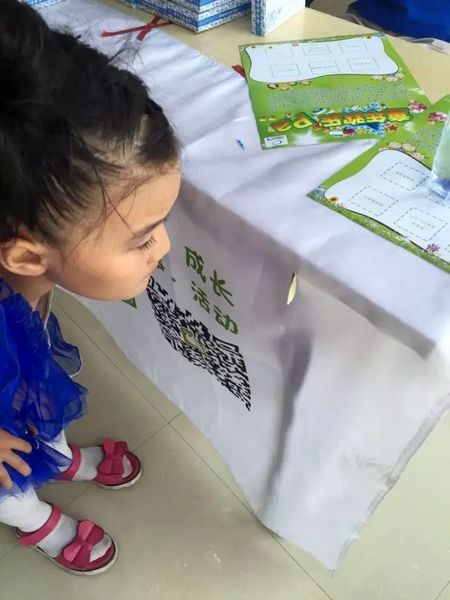 一只蝴蝶飛到小蝸牛的旗子上，小朋友看得入神啦~