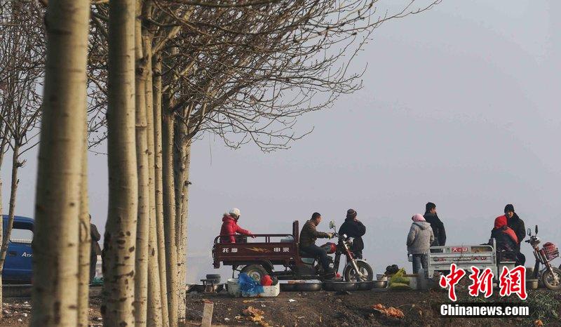 圖為12月1日，104國(guó)道靜?？h城附近，104國(guó)道靜?？h城附近，高速旁邊形成的黑市。田寶希 攝 圖片