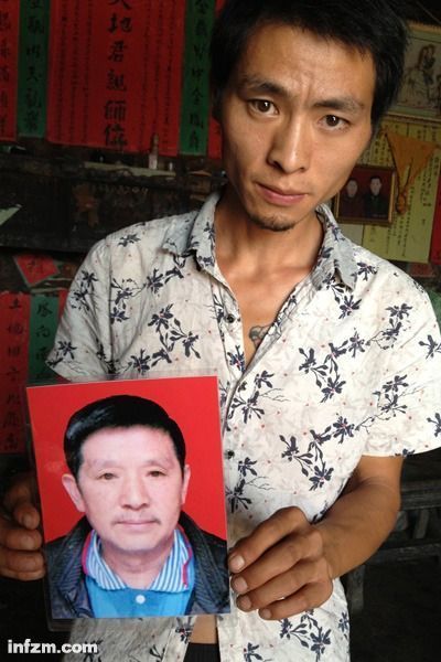 程興貴的兒子程正鵬拿著父親的遺照。程興貴自殺后，政府補償程家6000多塊錢，并終于認(rèn)定了程興貴的代課教齡。 (南方周末記者雷磊/圖)