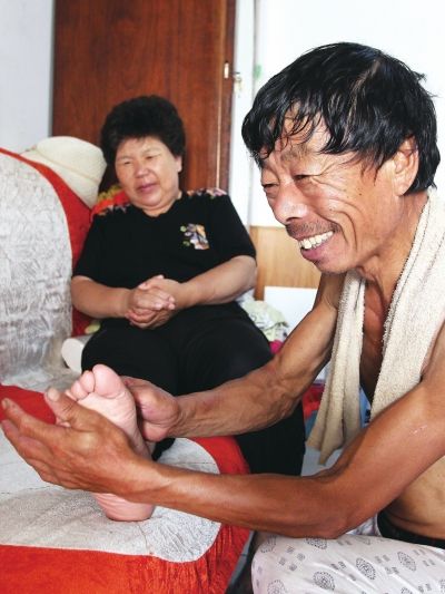慈成富為老伴按摩。