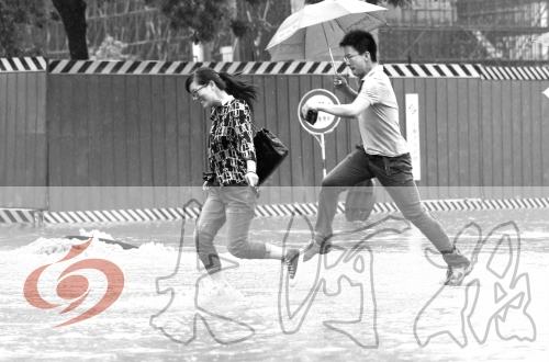 鄭州經(jīng)三路與北環(huán)交叉口處，積水較深，行人們不得不“練輕功”。 記者 白周峰 攝影