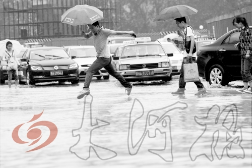 鄭州經(jīng)三路與北環(huán)交叉口處，積水較深，行人們不得不“練輕功”。 記者 白周峰 攝影