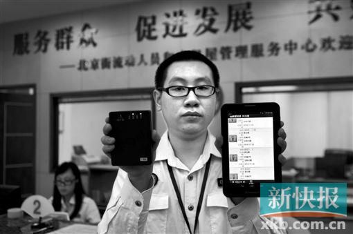 　越秀區(qū)北京街出租屋外來暫住人員管理服務(wù)中心的工作人員展示到出租屋登記來穗人員信息的儀器。