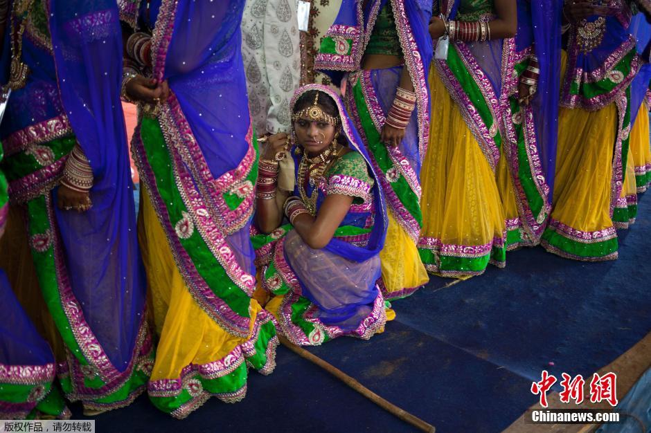 當(dāng)?shù)貢r(shí)間2014年6月15日,印度新德里,印度政府為數(shù)百對(duì)貧困新人舉辦集體婚禮。